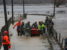 epa11404891 Carabineros and emergency personnel evacuate people who were isolated due to the overflowing of the Pichilo River, as a result of heavy rains in the Los Guzmanes sector, in the commune of Arauco, Bio Bio region, Chile, 11 June 2024. EPA/Ignacio Vasquez