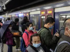epa08190679 Passengers wear face masks as they prepare to board a Hong Kong bound train at Lo Wu MTR station hours before the closing of the Lo Wu border crossing in Hong Kong, China, 03 February 2020. Hong Kong has announced the closure of the major land border crossings at Lo Wu and Lok Ma Chau to shut out the outbreak of the Wuhan coronavirus. Only Hong Kong International Airport, the Shenzhen Bay joint checkpoint and the Hong Kong-Zhuhai-Macau Bridge remain open. The outbreak originated in the Chinese city of Wuhan and has so far killed at least 361 people with over 17,000 infected, mostly in China. EPA/JEROME FAVRE