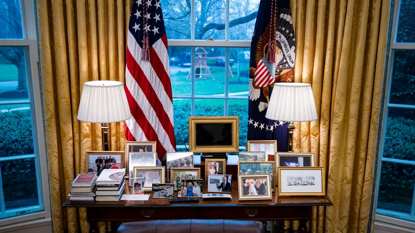 epa09831479 Family photos sit behind the Resolute desk, used by US President Joe Biden (not pictured), while meeting virtually with Micheal Martin, Ireland's prime minister, in the Oval Office of the White House in Washington, DC, USA, 17 March 2022. Martin tested positive for Covid-19 while in Washington for St. Patrick's Day celebrations. EPA/AL DRAGO / POOL