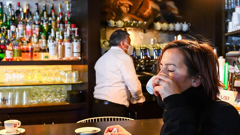 A woman drinks a coffe inside a bar in the centre of town as Regione Liguria shifts to ÒYellow ZoneÓ following government decisions in order to contain the Coronavirus pandemic, in Genoa, Italy, 29 November 2020 ANSA/SIMONE ARVEDA