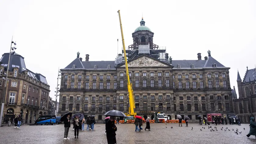 epa11214567 The bronze statue Prudentia (Caution) is removed from the roof of the Royal Palace on Dam Square in Amsterdam, The Netherlands, 11 March 2024, for maintenance. A total of two bronze statues will be removed from the roof, which is the first time since they were placed in the 17th century. EPA/Jeroen Jumelet