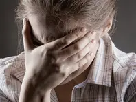 Young crying woman on a dark background