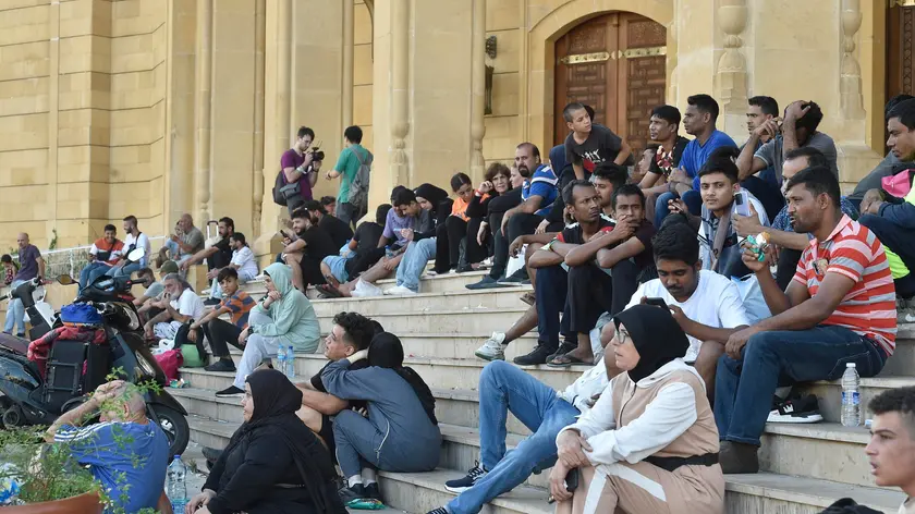 epa11630652 Residents gather with their belongings on the streets after fleeing their homes due to new Israeli strikes, Lebanon, 28 September 2024. According to the UN, the recent escalations in Lebanon, a 'catastrophic situation', have led to widespread destruction of homes and infrastructure across the country. At least 700 people have been killed, thousands have been injured, and nearly 120,000 people have been displaced in the past week. The Israeli army (Tsahal) said on 28 September 2024 on X (formerly Twitter) that Hezbollah leader Hassan Nasrallah was killed in an overnight strike on Beirut. Hezbollah confirmed the death of Nasrallah in a statement on 28 September 2024. EPA/WAEL HAMZEH