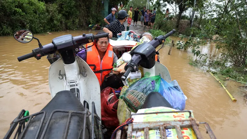 epa11596100 Local residents are evacuated on a boat at a flooded street in Hanoi, Vietnam, 10 September 2024. Typhoon Yagi, which struck northern Vietnam over the weekend, triggered severe flooding in Hanoi. The Red River's rapid rise inundated communities along the riverbank, forcing residents to seek refuge in safer areas. As of 09 September, the Vietnam Disaster and Dyke Management Authority reported at least 65 fatalities and 39 missing persons due to the typhoon. According to UNICEF, millions of families were affected by the widespread flooding and landslides caused by Yagi when it made landfall on 07 September. EPA/LUONG THAI LINH