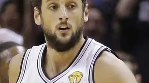 San Antonio Spurs guard Marco Belinelli (3) and guard Tony Parker, right, celebrate against the Miami Heat during the first half in Game 2 of the NBA basketball finals on Sunday, June 8, 2014, in San Antonio. (AP Photo/Eric Gay)