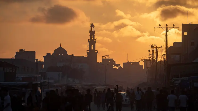 epa11404577 Palestinians walk at sunset in a destroyed street of Khan Yunis refugee camp, southern Gaza Strip, 11 June 2024. More than 37,000 Palestinians and over 1,400 Israelis have been killed, according to the Palestinian Health Ministry and the Israel Defense Forces (IDF), since Hamas militants launched an attack against Israel from the Gaza Strip on 07 October 2023, and the Israeli operations in Gaza and the West Bank which followed it. EPA/HAITHAM IMAD