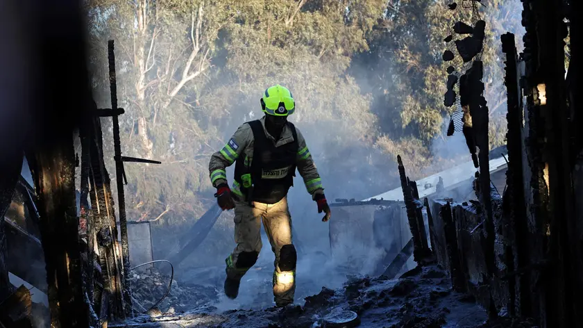 epa11617817 A firefighter douses a fire coming from projectiles fired from south Lebanon near Safed, northern Israel, 21 September 2024. The Israeli Defense Forces (IDF) said that "approximately 90 projectile launches were identified crossing from Lebanon into Israeli territory." Furthermore, the Air Force "struck thousands of launcher barrels that were ready for immediate use to fire toward Israeli territory." EPA/ATEF SAFADI