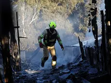 epa11617817 A firefighter douses a fire coming from projectiles fired from south Lebanon near Safed, northern Israel, 21 September 2024. The Israeli Defense Forces (IDF) said that "approximately 90 projectile launches were identified crossing from Lebanon into Israeli territory." Furthermore, the Air Force "struck thousands of launcher barrels that were ready for immediate use to fire toward Israeli territory." EPA/ATEF SAFADI