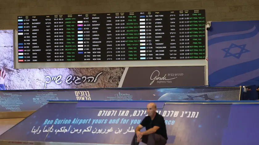 epa11579209 A man sits beneath the flight schedule board at the Ben Gurion International Airport after Israeli trade unionist and chairman of Histadrut, Arnon Bar-David, announced a general strike; in Tel Aviv, Israel, 02 September 2024. Israel's largest labor union, Histadrut, called for a nationwide general strike to start on 02 September urging the Israeli Prime Minister to reach a deal to secure the remaining hostages held by Hamas following the 07 October attack. Thousands of Israelis protested across Israel on 01 September following the recovery of the bodies of six hostagres held by Hamas in the Gaza Strip. According to a statement by the Israeli Government Press Office, 97 Israeli hostages remain in captivity in the Gaza Strip, with 33 confirmed dead. EPA/ABIR SULTAN
