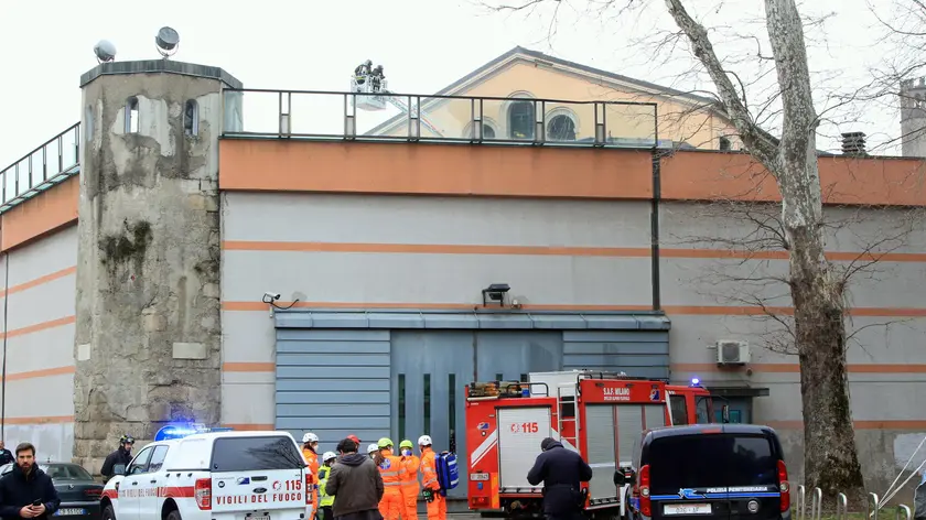 Law enforcement officers and firefighters in the area of the San Vittore prison, where a riot of inmates broke out, in Milan, Italy, 09 March 2020. There were violent protests by prisoners in Italy's jails against the restriction of face time with visiting relatives due to the coronavirus.ANSA / PAOLO SALMOIRAGO