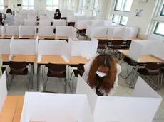 epa08418508 Teachers set up dividers on tables in a cafeteria of Duksoo High School in Seoul, South korea, 13 May 2020. The school will reopen on 20 May 2020. EPA/YONHAP SOUTH KOREA OUT