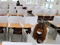 epa08418508 Teachers set up dividers on tables in a cafeteria of Duksoo High School in Seoul, South korea, 13 May 2020. The school will reopen on 20 May 2020. EPA/YONHAP SOUTH KOREA OUT