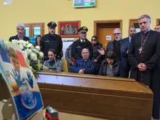 Corrado Lorefice, arcivescovo di Palermo, recita il Padre Nostro accanto ai Parenti di Antonella Salamone, il Fratello Calogero il padre Angelo e la mamma Rosalia, alla camera ardente nella sede del consiglio comunale per i due fratelli uccisi ad Altavilla Milicia, 19 febbraio 2024. ANSA/ IGOR PETYX