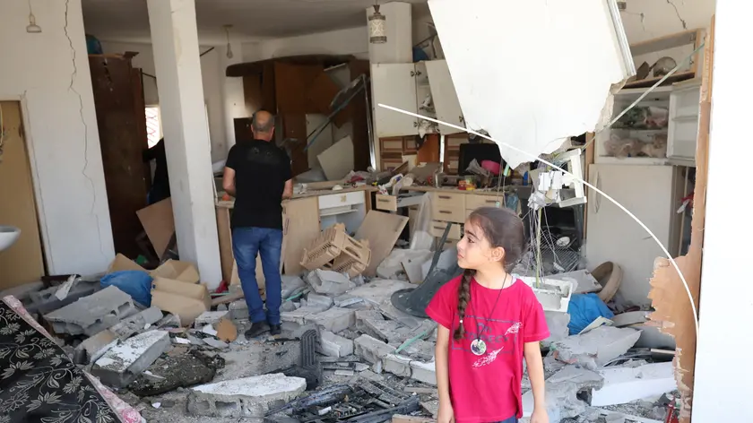 epa11405133 A young Palestinian girl inspects the damage at her house following an Israeli raid in the village of Kafr Dan near the West Bank city of Jenin, 12 June 2024. According to the Palestinian Health Ministry, at least six Palestinians were killed in the operation. EPA/ALAA BADARNEH