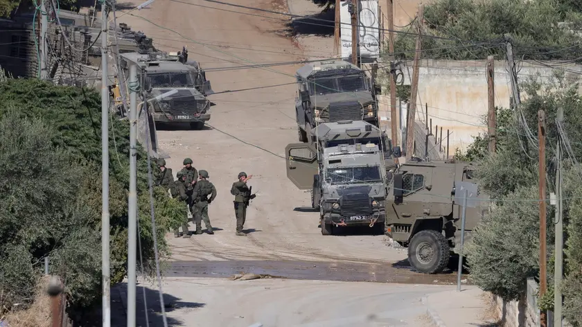 epa11581237 Israeli troops conduct a military operation in the West Bank city of Jenin, 03 September 2024. According to the Palestinian Health Ministry, at least 27 Palestinians have been killed since Israeli military operations started on 28 August 2024 in the West Bank cities of Tulkarem, Jenin, and Tubas. The Israeli army said that it's conducting a large-scale 'counterterrorism operation' in several areas. EPA/ALAA BADARNEH