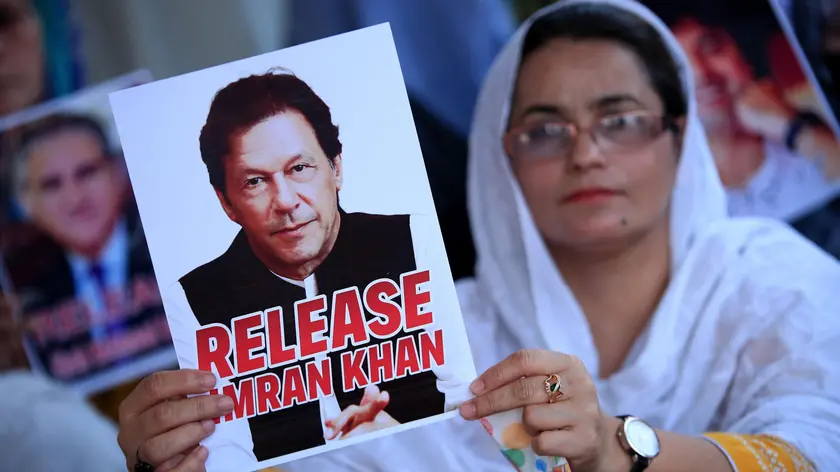 epa11494389 A supporter of the Pakistan Tehreek-e-Insaf (PTI) party holds a portrait of party founder and convicted former prime minister Imran Khan during a hunger strike camp to demand the release of Imran Khan and his wife Bushra Bibi, in Peshawar, Pakistan, 24 July 2024. PTI lawmakers in the national assembly (lower house of the parliament), led by Opposition Leader Omar Ayub, have also launched a hunger strike camp outside the Parliament, to demand the release of party founder Imran Khan, and protest against the arrests of the party's social media activists, and address rising inflation. EPA/BILAWAL ARBAB