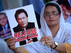 epa11494389 A supporter of the Pakistan Tehreek-e-Insaf (PTI) party holds a portrait of party founder and convicted former prime minister Imran Khan during a hunger strike camp to demand the release of Imran Khan and his wife Bushra Bibi, in Peshawar, Pakistan, 24 July 2024. PTI lawmakers in the national assembly (lower house of the parliament), led by Opposition Leader Omar Ayub, have also launched a hunger strike camp outside the Parliament, to demand the release of party founder Imran Khan, and protest against the arrests of the party's social media activists, and address rising inflation. EPA/BILAWAL ARBAB