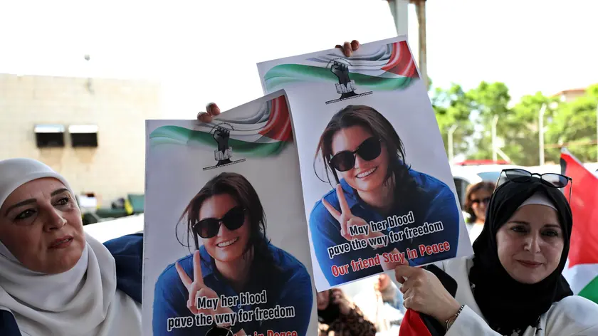epa11593149 Palestinians and international activists hold photos of late Turkish-American activist Aysenur Ezgi Eygi, at the Rafidia hospital morgue, in the West Bank city of Nablus, 08 September 2024. According to the Palestinian news agency WAFA, the 26-year-old activist succumbed to her wounds after being shot in the head by Israeli forces during a protest against settlement expansion in Beita, near Nablus, on 06 September. She was taken to hospital, where she was pronounced dead, WAFA added. EPA/ALAA BADARNEH