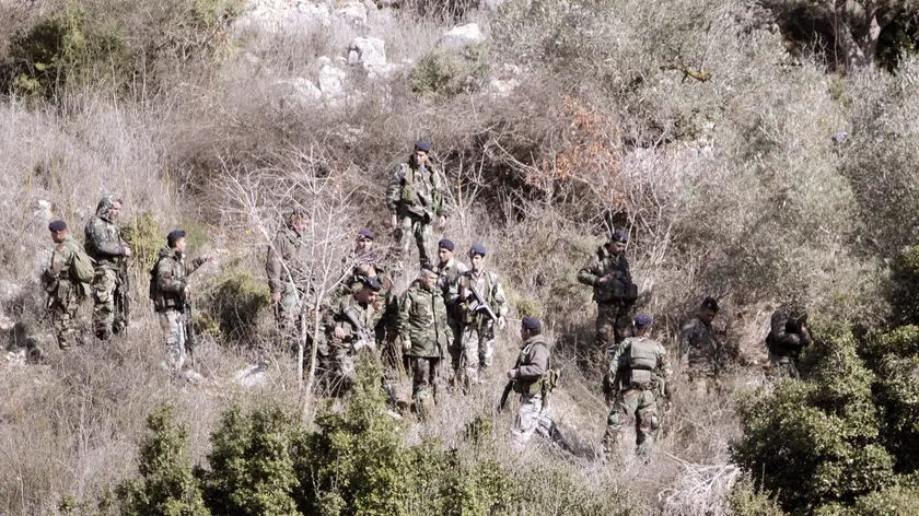 epa03018850 Lebanese army soldiers, inspect the area where rockets were fired from south Lebanon to north Israel, near the village of Ain Ebel, southern Lebanon, 29 November 2011. Rockets were fired from Lebanon to northern Israel early 29 November 2011, where a burst of Israeli artillery fire across the border to Lebanese villages. According to Lebanese media reports, Abdullah Azzam Brigades, an Islamist militant group affiliated with Al-Qaeda, claimed responsibility. EPA/HASSAN BAHSOUN