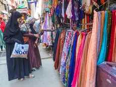 epa11265396 Kashmiri Muslim women check a dress as they shop ahead of the Eid al-Fitr holiday in Srinagar, the summer capital of Indian Kashmir, 08 April 2024. Eid al-Fitr is an Islamic holiday that marks the end of Ramadan, and is celebrated during the first three days of Shawwal, the 10th month of the Islamic calendar. It is expected to begin on 10 or 11 April 2024, depending on the lunar calendar. EPA/FAROOQ KHAN 49010