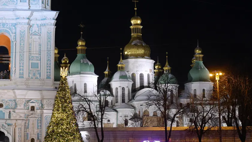 epa11014254 People look at the Christmas tree in front of Saint Sophia's Cathedral in Kyiv, Ukraine, 06 December 2023 as they celebrate St. Nicholas Day. The Saint Nicholas Day celebration, traditionally is a festival for children in most Orthodox countries in Europe related to surviving legends of Saint Nicholas, and particularly his reputation as a bringer of gifts. Since this year, Ukraine is marking Saint Nicholas Day on 06 December and Christmas on 25 December together with Europe according to the Gregorian calendar, unlike in previous years when Ukraine marked St. Nicholas on 19 December and Christmas on 07 January with other post-Soviet countries. EPA/SERGEY DOLZHENKO