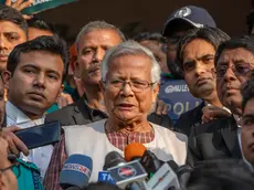 epa11052124 Bangladeshi Nobel peace laureate Muhammad Yunus (C) talks to the media outside the Dhaka Labor Court in Dhaka, Bangladesh, 01 January 2024. Yunus and three other top officials of Grameen Telecom were sentenced to six months of imprisonment in a case over labor law violations. EPA/MONIRUL ALAM