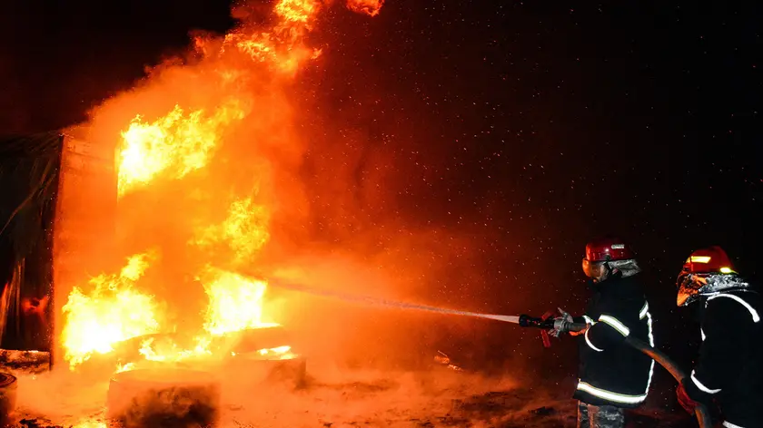 epa09658692 A handout photo made available by the official Syrian Arab News Agency (SANA) shows firefighters working at the Latakia port in northern Syria, 28 December 2021. According to official Syrian reports, Israel carried out a missile attack targeting the container yard in the commercial port in Lattakia, causing significant material damages. The Israel Defense Forces did not comment on the reports. EPA/SANA HANDOUT HANDOUT EDITORIAL USE ONLY/NO SALES