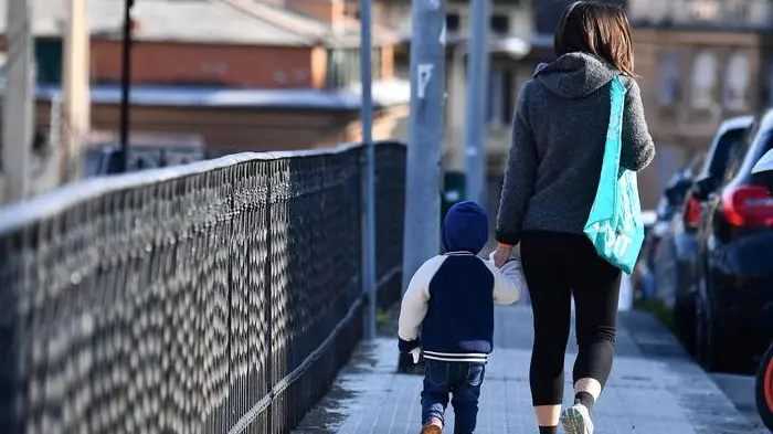 One of the very few mothers with her baby traveling around the city, Genova, Italy, 30 March 2020. Countries around the world are taking measures to stem the widespread of the SARS-CoV-2 coronavirus which causes the Covid-19 disease. ANSA/LUCA ZENNARO