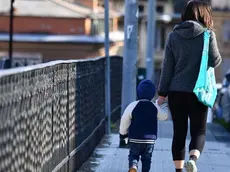 One of the very few mothers with her baby traveling around the city, Genova, Italy, 30 March 2020. Countries around the world are taking measures to stem the widespread of the SARS-CoV-2 coronavirus which causes the Covid-19 disease. ANSA/LUCA ZENNARO