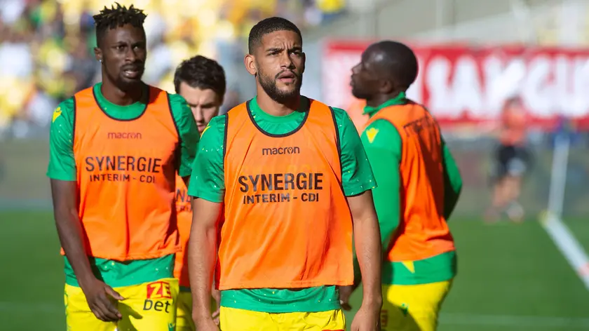 Nantes' French-Cameroonian defender Jean-Charles Castelletto (C) looks on prior to the start of the French L1 football match between FC Nantes and AC Ajaccio at the Beaujoire - Louis Fonteneau stadium in Nantes on November 13, 2022. (Photo by Sebastien SALOM-GOMIS / AFP)