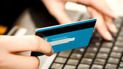 Online shopping with credit card on laptop