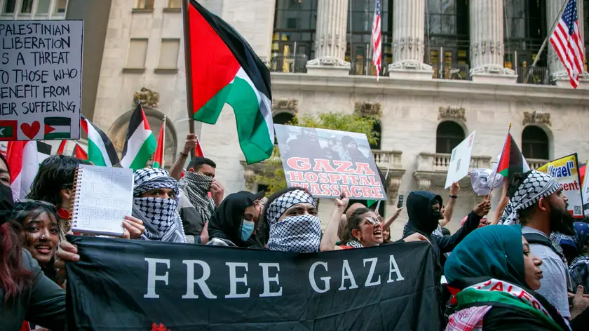epa10941858 People protest in support of Palestine in front of the New York Stock Exchange on Wall Street in New York, New York, USA, 26 October 2023. The group is protesting U.S. weapons manufactures and investment companies making the bombs being dropped on Gaza. Thousands of Israelis and Palestinians have died since the militant group Hamas launched an unprecedented attack on Israel from the Gaza Strip on 07 October, and the Israeli strikes on the Palestinian enclave which followed it. EPA/SARAH YENESEL