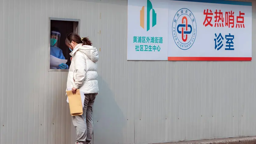 epa10496592 A woman stands ot the window of a container turned into a Covid-19 fever clinic, in Shanghai, China, 01 March 2023. US Director of the Federal Bureau of Investigation (FBI) Christopher Wray on 28 February said 'the origins of the COVID-19 pandemic likely originated from a lab incident in Wuhan, China.' EPA/ALEX PLAVEVSKI