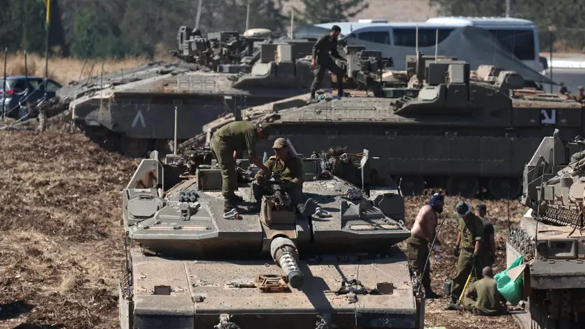 epa11630007 Israeli soldiers man tanks at a gathering point in northern Israel, 28 September 2024. The Israeli army (Tsahal) said on 28 September that military forces continue to strike infrastructure sites of the Hezbollah organization in Lebanon. The army struck over 140 Hezbollah targets since midnight 28 September, including launchers aimed at Israeli civilians, and buildings in which weapons were stored, the report said. Hezbollah leader Hassan Nasrallah was killed in an overnight strike on Beirut, the Hezbollah and Tsahal confirmed in statements on 28 September 2024. EPA/ATEF SAFADI