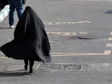 epa11605787 A veiled Iranian woman walks in a street in Tehran, Iran, 15 September 2024, on the second anniversary of protests following Mahsa Amini's death. Mahsa Amini, a 22-year-old Iranian woman, was arrested in Tehran on 13 September 2022 by the police unit responsible for enforcing Iran's strict dress code for women. She fell into a coma while in police custody and was declared dead on 16 September 2022. Her death led to anti-government protests worldwide. EPA/ABEDIN TAHERKENAREH