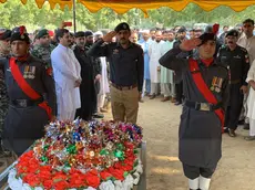 epa11598234 District Police Officer of Bajaur Waqas Rafique (C) lays a wreath during the funeral of a police officer who was killed after an attack by suspected militants during a polio vaccination campaign near the Afghan border in Bajaur, Pakistan, 11 September 2024. A polio vaccination team was attacked by suspected militants, near the Afghan border in Bajaur district, Khyber Pakhtunkhwa, resulting in the deaths of a polio worker and a police officer providing security. The police cordoned off the area and initiated a search operation for the attackers, while the bodies were taken to Khar Hospital. This incident highlights the ongoing violence aimed at disrupting polio eradication efforts in the region, despite existing security measures. EPA/HANIFULLAH KHAN