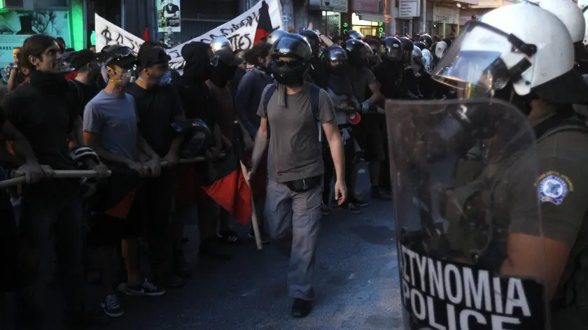 epa03874604 Demonstrators rally during a protest march against fascism in the district of Keratsini, Athens, Greece, 19 September 2013. According to reports, thousands of protesters took to the streets protesting against the murder of 34 year-old leftist hip hop artist Pavlos Fissas, allegedly killed by a neonazi a day earlier, and demanding a ban of the ultra-right party Golden Dawn. EPA/ORESTIS PANAGIOTOU
