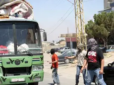 epa03363157 Members of a Lebanese Salafist group inspect a Syrian vehicle at a checkpoint in Majdal Anjar, near the Lebanese-Syrian border, eastern Lebanon, 16 August 2012. A group of masked Sunni youths set up barriers on the main road in Majdal Anjar, reportedly known for protecting Sunni fundamentalist fugitives, to the Lebanon-Syria al-Masnaa border crossing, carrying out ID checks before deciding whether to let them pass. A spokesman for the group, Ali Abdul Khaliq, said their action was in response to the recent kidnappings of Sunnis by Shiites in Beirut. Arab countries, including Saudi Arabia, Kuwait, Qatar and the United Arab Emirates, on 16 August started evacuating their citizens from Lebanon over a series of kidnappings of Sunni Muslim foreigners by a Lebanese Shiite clan demanding the release of one of its members held by Syrian rebels. The kidnappings raised fears that the Syrian conflict was spilling over the border into Lebanon, which is divided along sectarian lines that mirror those in Syria. EPA/LUCIE PARSEGHIAN