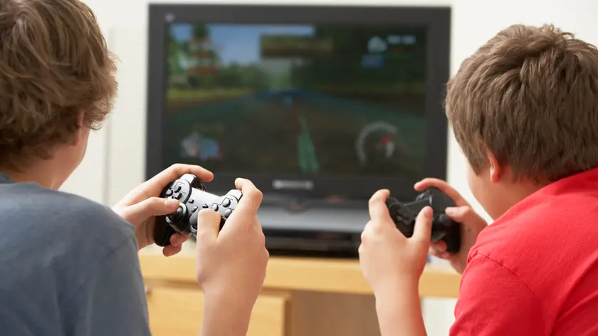 Two Boys Playing With Game Console