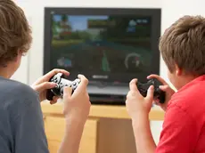 Two Boys Playing With Game Console