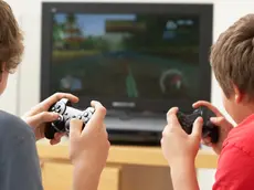 Two Boys Playing With Game Console
