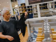 epa10790162 An elderly man shops at a clothing shop in Beijing, China, 08 August 2023. China's trade surplus dropped to 80.6 billion US dollar (73.36 billion Euro) in July 2023, from 102.7 billion US dollar (93.47 billion euro) in the same period the prior year, as exports fell more than imports amid demand weakened from home and abroad, the General Administration of Customs reported. EPA/WU HAO