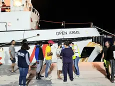The ship Open Arms in the port of Lampedusa, 21 August 2019. In the dock doctor Francesco Cascio (R-with mask), the head of the Lampedusa Clinic, visits the refugees, then they are invited to board the buses that, as soon as the procedures are finished, will take them to the hotspot. ANSA / ELIO DESIDERIO