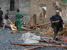 epa11280597 People salvage their belongings after heavy rains in Momand-Dara district of Nangarhar province, Afghanistan, 15 April 2024. According to the Afghanistan disaster management department, at least 33 people have been killed over three days of heavy rains and flash flooding. Authorities warned that Afghanistan's provinces will see more rain over the next few days. EPA/STRINGER