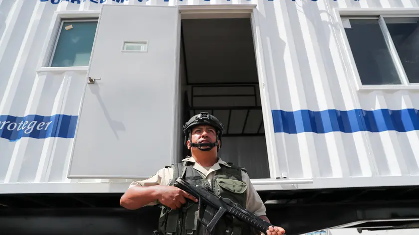 epa11138307 A member of police stands next to a mobile barrack donated by the US government to the Ecuadorian Police, in Quito, Ecuador, 08 February 2024. The United States Government announced the donation to the National Police of Ecuador of 'sophisticated' mobile barracks to monitor the border with Colombia, as part of a process of cooperation in security and combating crime. EPA/Jose Jacome