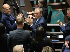 epa11025423 New Polish Prime Minister Donald Tusk (C) is congratulated in the Sejm, the lower house of parliament, after his government faced a confidence vote in Warsaw, Poland, 12 December 2023. The opposition government presented by Donald Tusk, the newly elected prime minister, has secured a vote of confidence in the Sejm. In the vote, 248 MPs dominated by opposition parties voted for the government, while 201 MPs were against it and no-one abstained. EPA/Pawel Supernak POLAND OUT