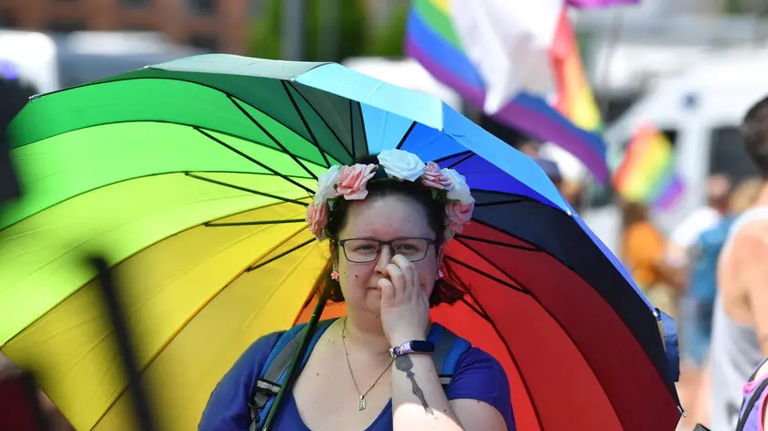 epa09302612 A person holding an umbrealla with the rainbow colors takes part in the Equality March, an LGBT community pride parade, in Lodz, Poland, 26 June 2021. This year's march is held under the slogan 'let live'. EPA/GRZEGORZ MICHALOWSKI POLAND OUT