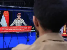 epa11229586 A person watches Houthi military spokesman Yahya Sarea delivering a TV statement over new shipping attacks, in Sana'a, Yemen, 19 March 2024. Yemen's Houthis have launched new missile attacks against a tanker, MADO, in the Red Sea, and Israel's Eliat region, which borders the Red Sea, according to a TV statement by Houthi military spokesman Yahya Sarea. The US-led coalition continues to strike Houthi targets in Yemen as it seeks to degrade the Houthis' abilities to attack commercial shipping vessels in the Red Sea and the Gulf of Aden amid high tensions in the Middle East. In light of increased maritime security threats, the US has designated the Houthis as a 'Specially Designated Global Terrorist Group'. EPA/YAHYA ARHAB
