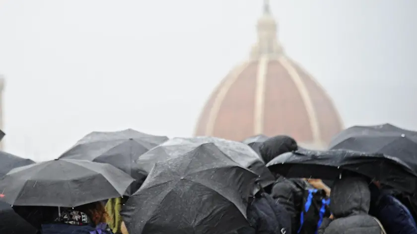 Fiorentini e turisti si riparano dalla pioggia abbondante a Firenze 10 febbraio 2014. ANSA/MAURIZIO DEGL' INNOCENTI