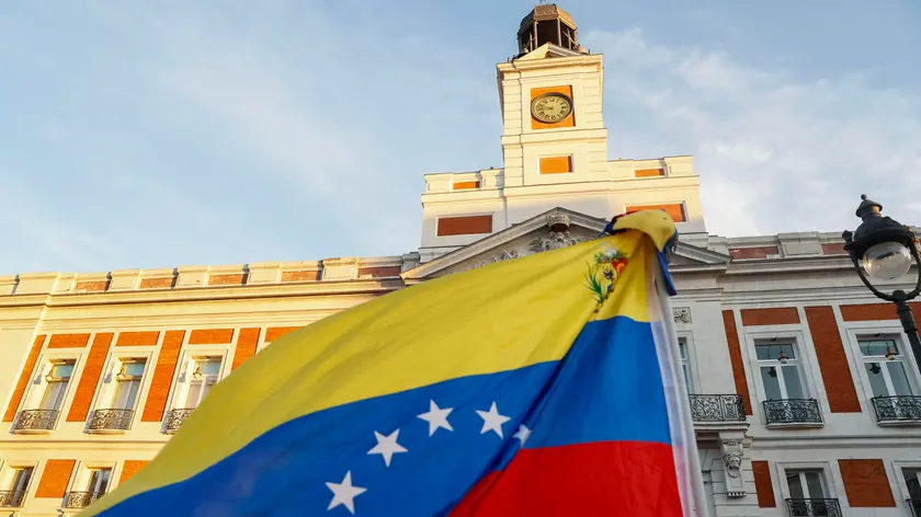 epa11553434 A Venezuelan flag flutters during a demonstration against the official results of Venezuela's presidential elections, in Madrid, Spain, 17 August 2024. The Venezuelan National Electoral Council (CNE) ratified the victory of Nicolas Maduro in Venezuela's presidential elections held on 28 July 2024, while the opposition have been protesting against the official results claiming the victory of Edmundo Gonzalez Urrutia. EPA/FERNANDO ALVARADO